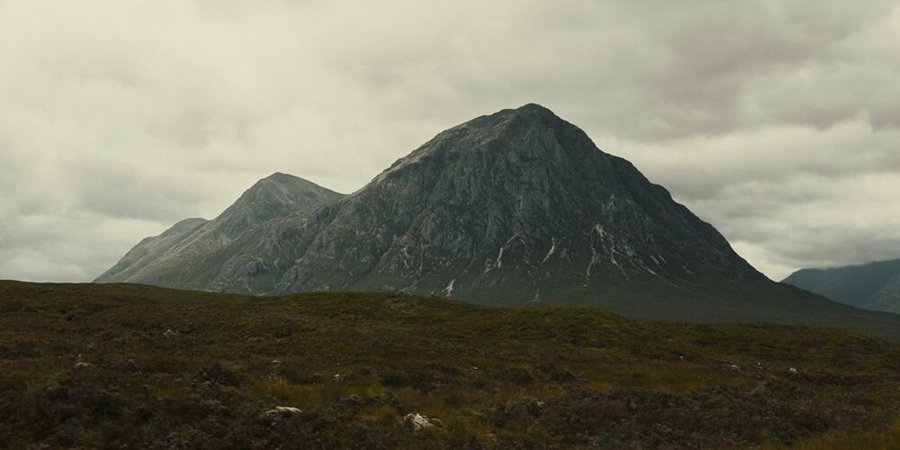 Scenic view of mountains against cloudy sky