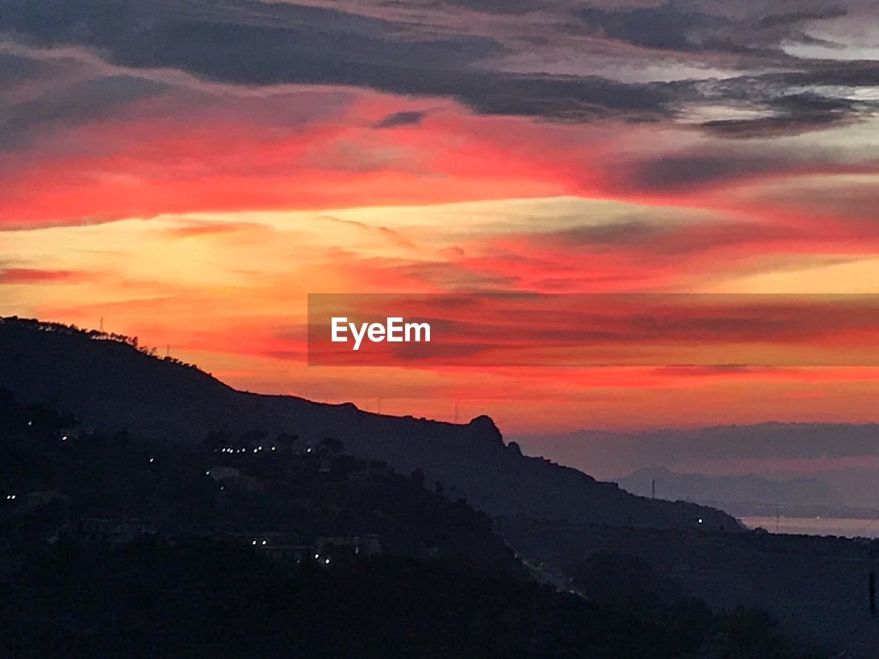 SCENIC VIEW OF SILHOUETTE MOUNTAINS AGAINST ROMANTIC SKY