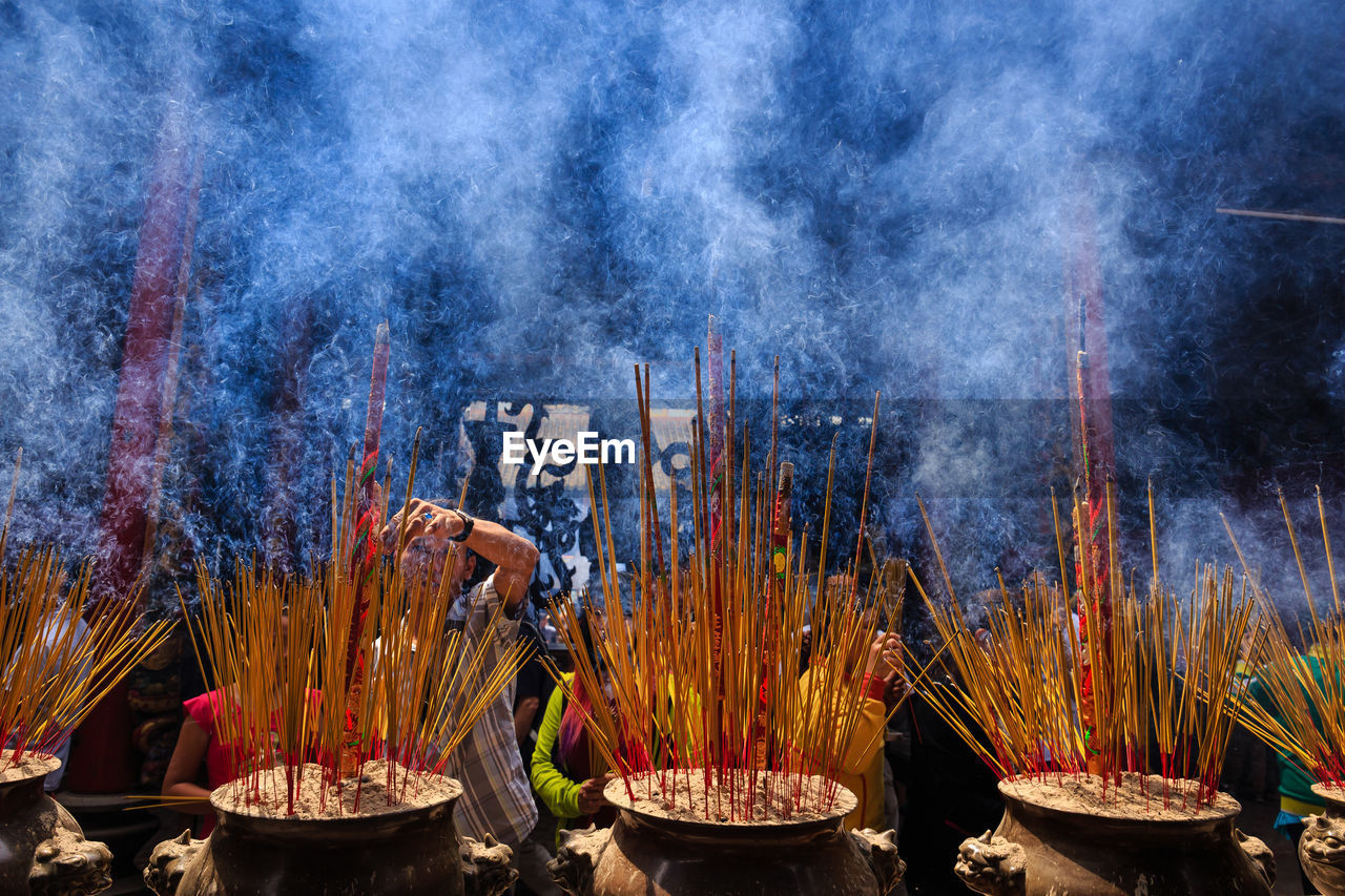 Smoke emitting from incense sticks in temple