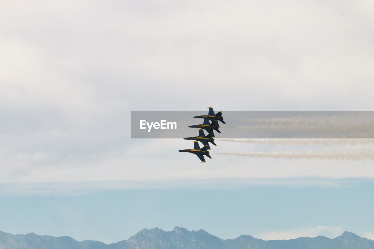 LOW ANGLE VIEW OF AIRPLANE IN SKY