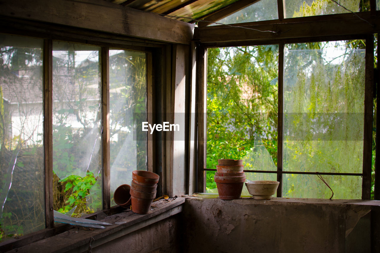 Earthen pots at window in abandoned building