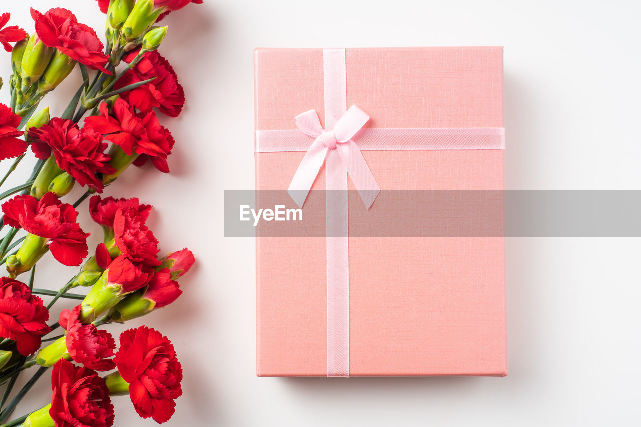 Close-up of flowers and christmas present on table