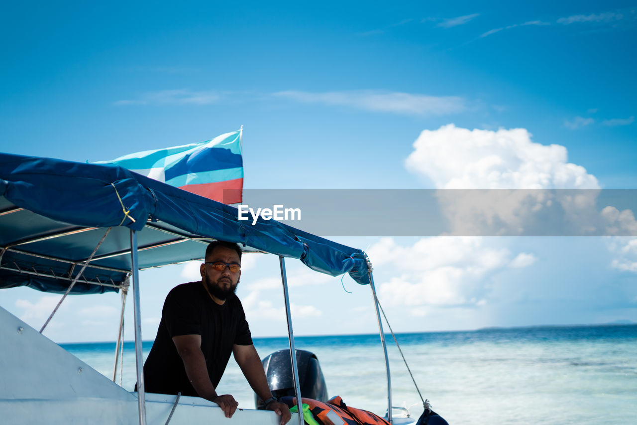 Man on sea against sky