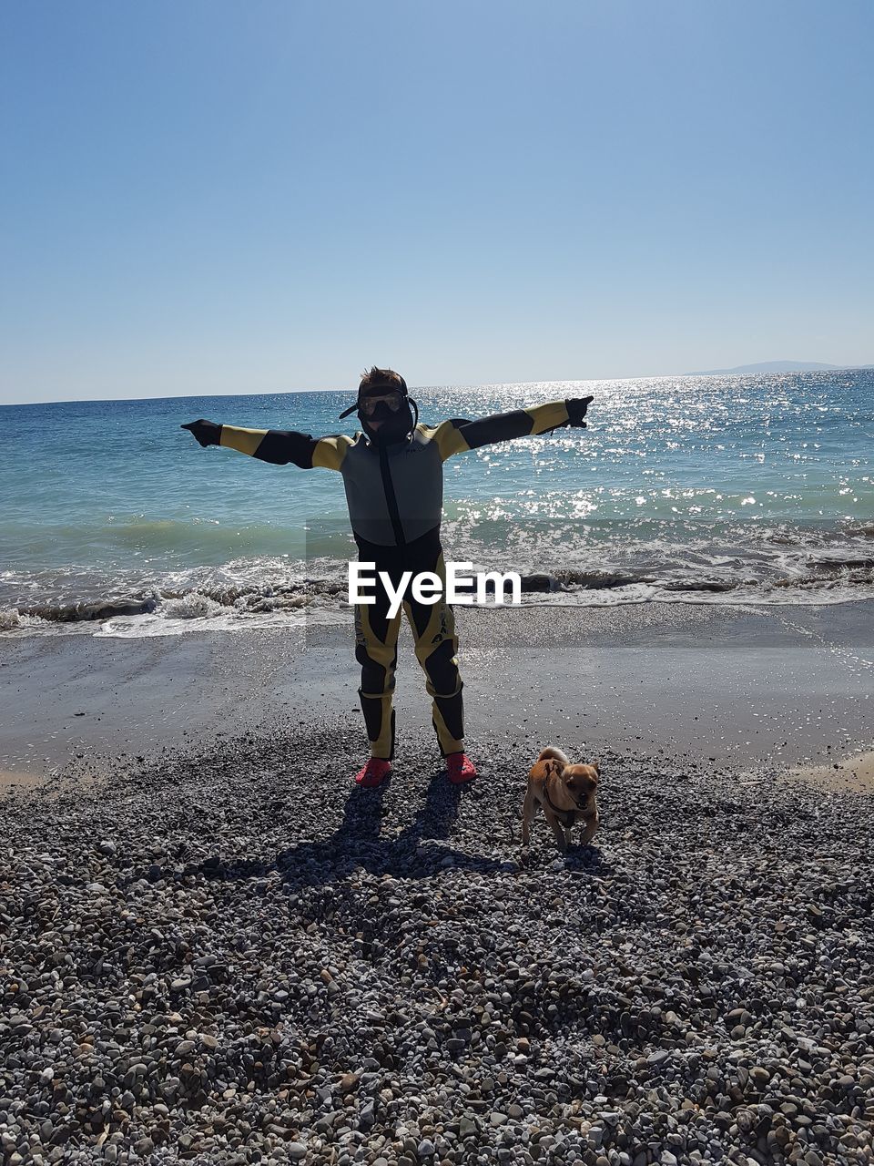 WOMAN WITH DOG ON BEACH