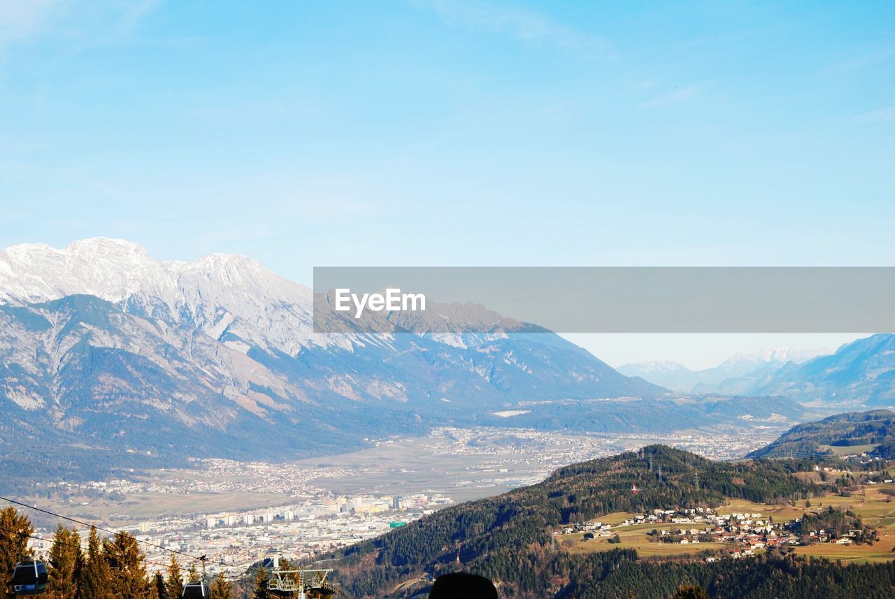 Scenic view of mountains against blue sky