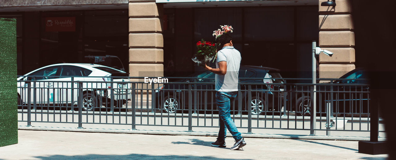 MAN WITH UMBRELLA IN CITY