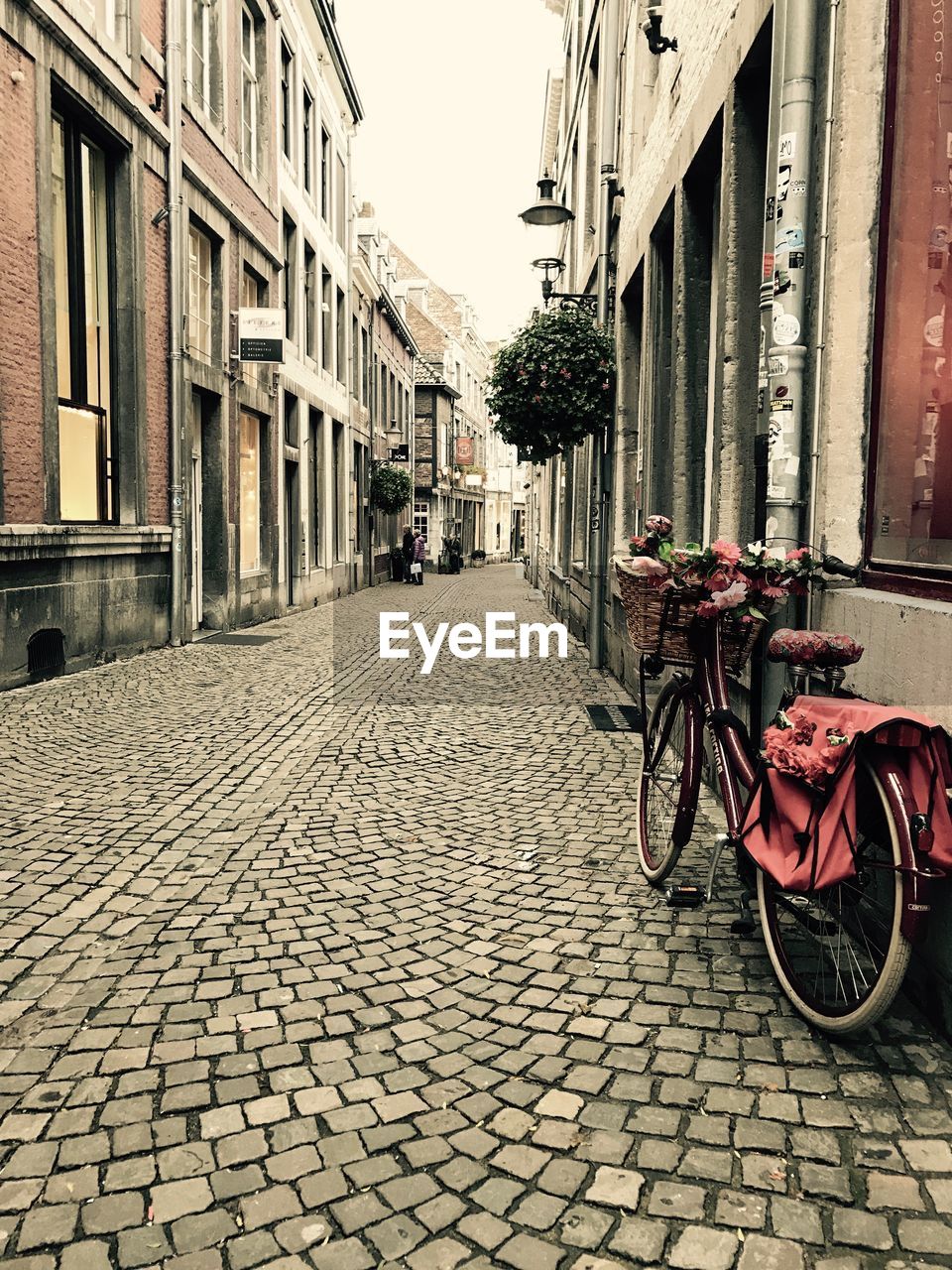 BICYCLE ON COBBLESTONE STREET IN CITY