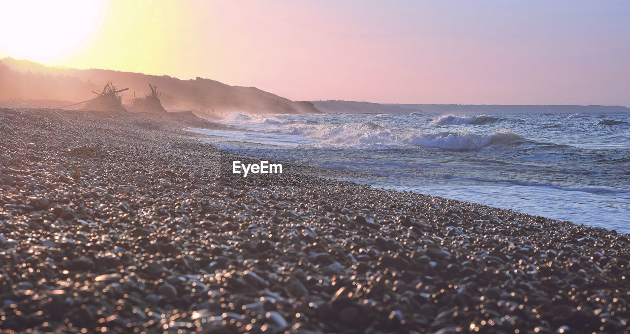 Sky Beauty In Nature Sunset Land Scenics - Nature Sea Beach Tranquil Scene Water Tranquility Wave Nature Motion Idyllic No People Horizon Sand Clear Sky Horizon Over Water Outdoors Surface Level Sun Ocean