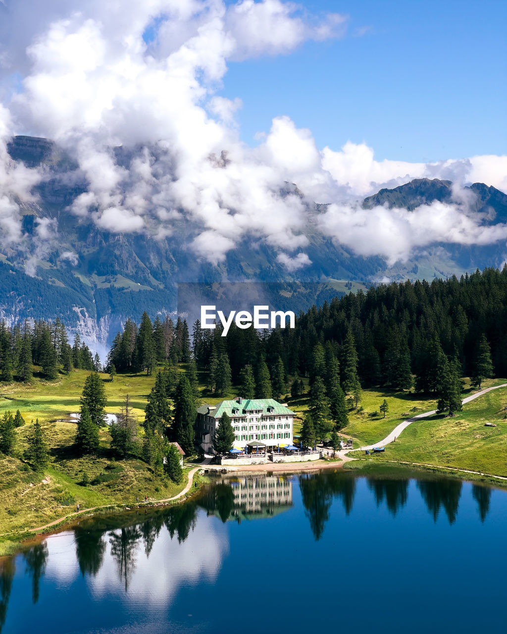 Scenic view of hotel reflected in a lake against sky