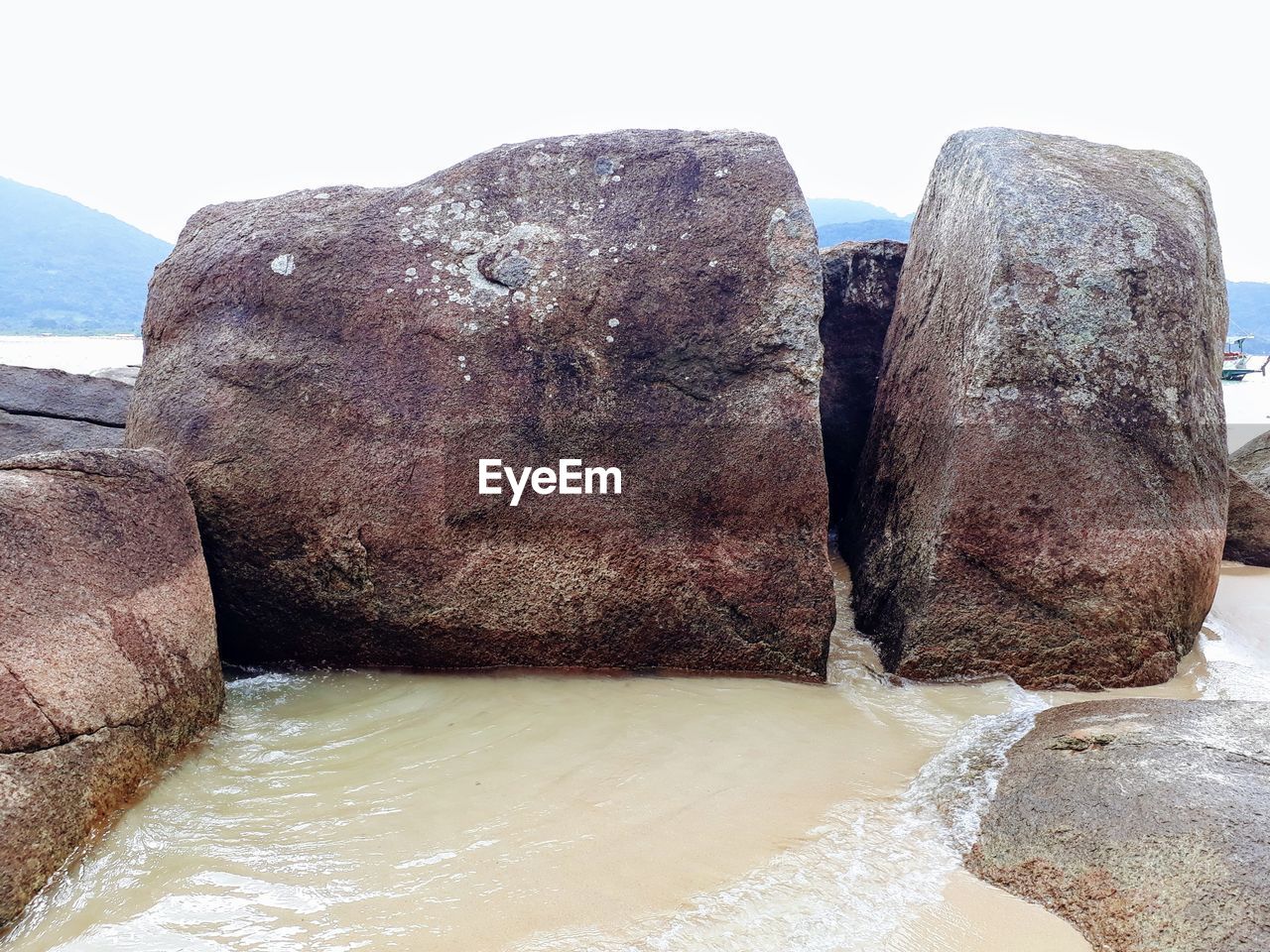 CLOSE-UP OF ROCKS IN SEA