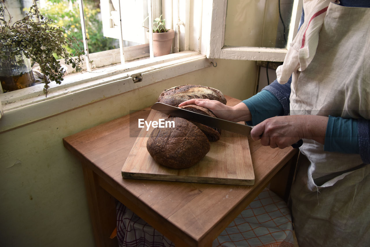 Midsection of man preparing food at home