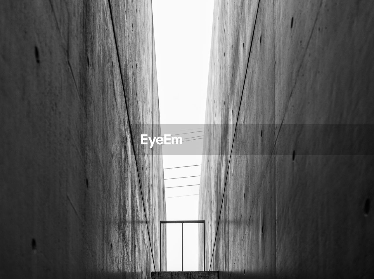 LOW ANGLE VIEW OF BUILDING AGAINST SKY SEEN THROUGH WINDOW