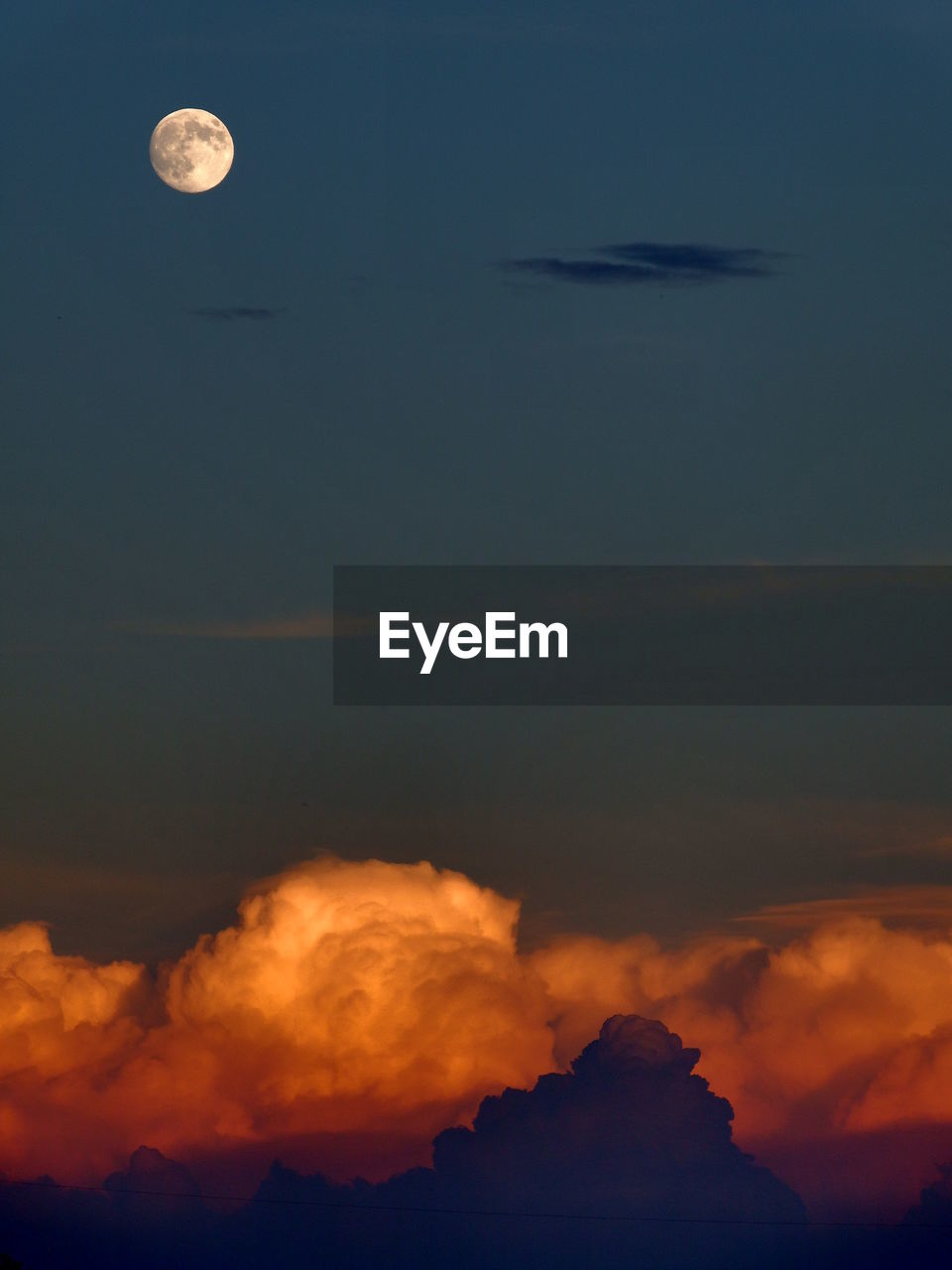 Scenic view of moon against sky at sunset