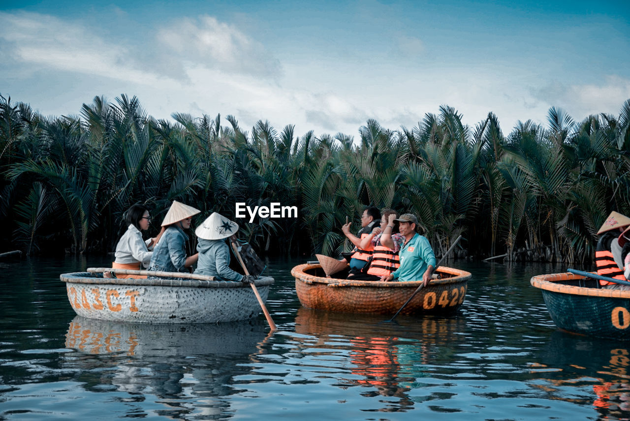 PANORAMIC VIEW OF PEOPLE ON BOATS IN WATER