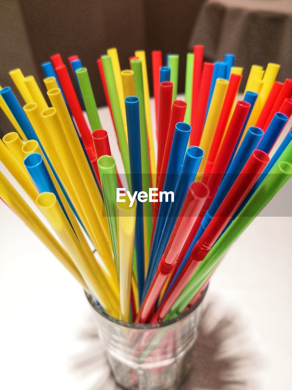 High angle view of multi colored drinking straws on table