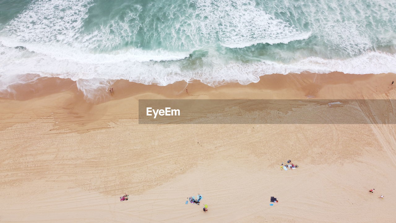 Aerial view of waves against coast