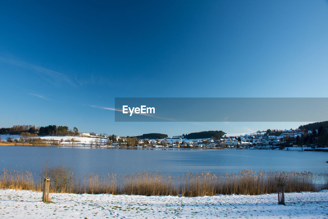 Scenic view of frozen lake against sky during winter