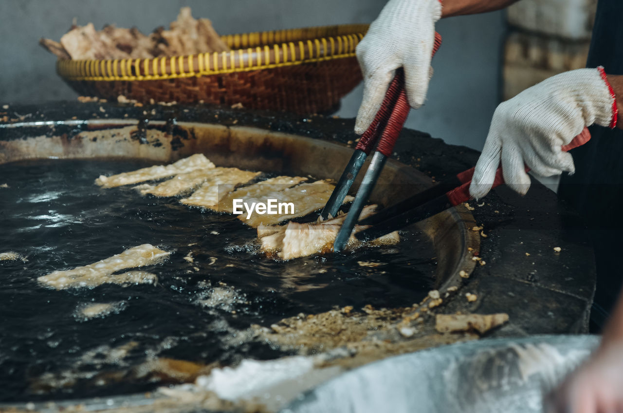 Cropped hand of man preparing food