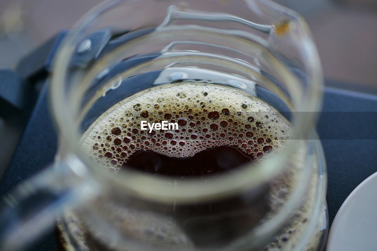 HIGH ANGLE VIEW OF DRINKING GLASS