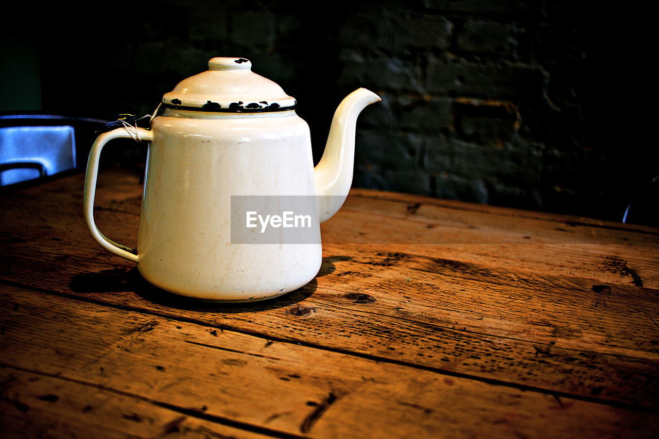Close-up of tea kettle on wooden table