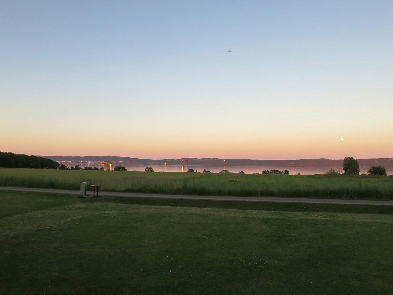 Grassland against clear sky