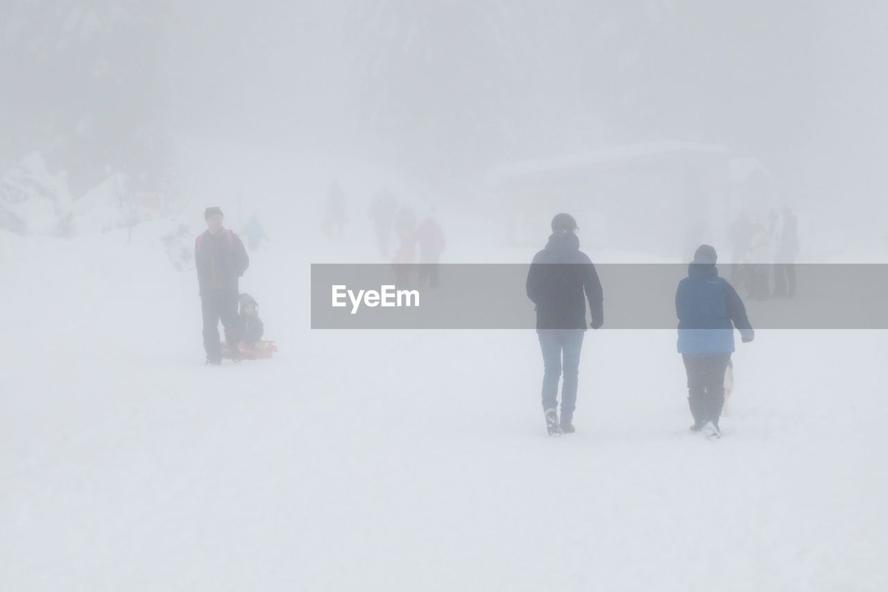 PEOPLE ON SNOW AGAINST SKY