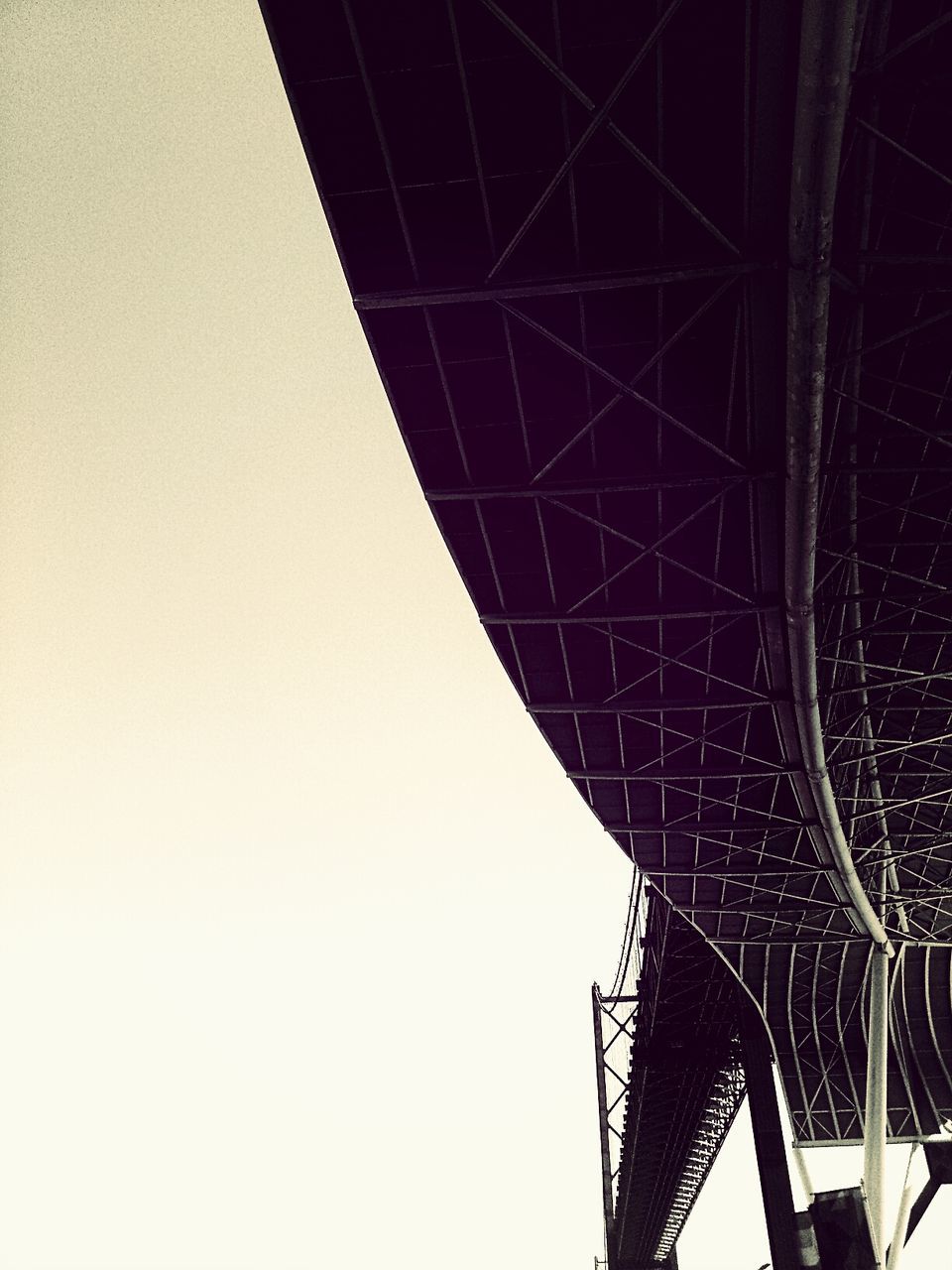 Low angle view of cropped bridge against clear sky