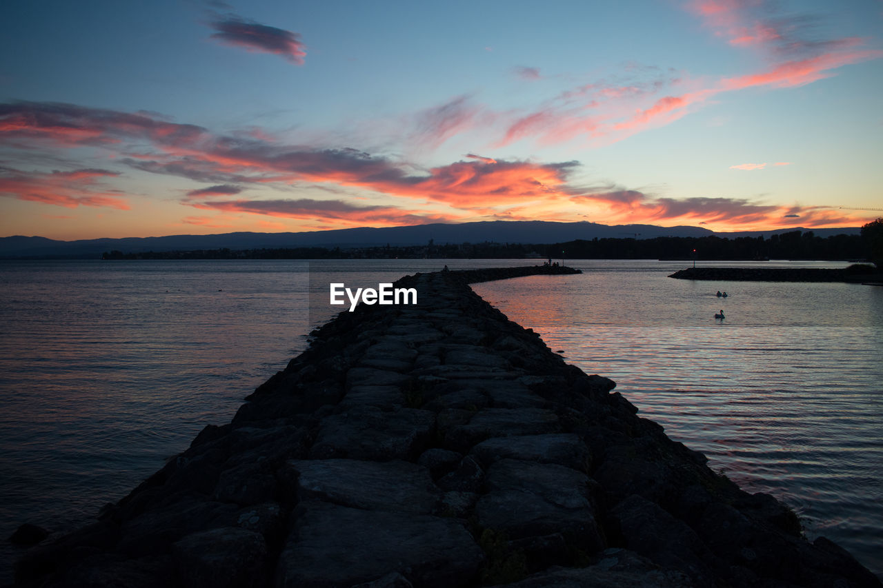 Scenic view of lake against sky during sunset