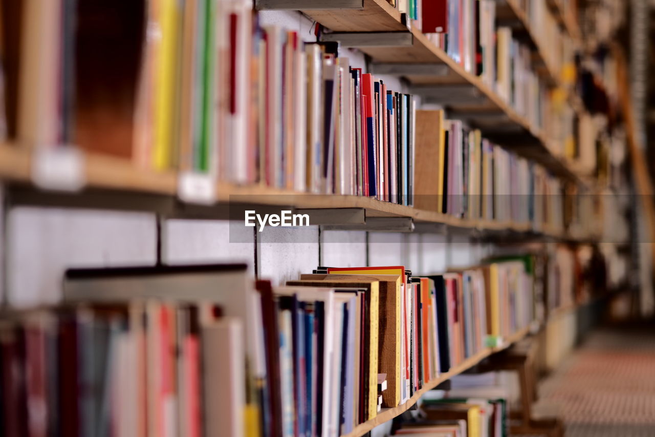 Books arranged on shelf in library