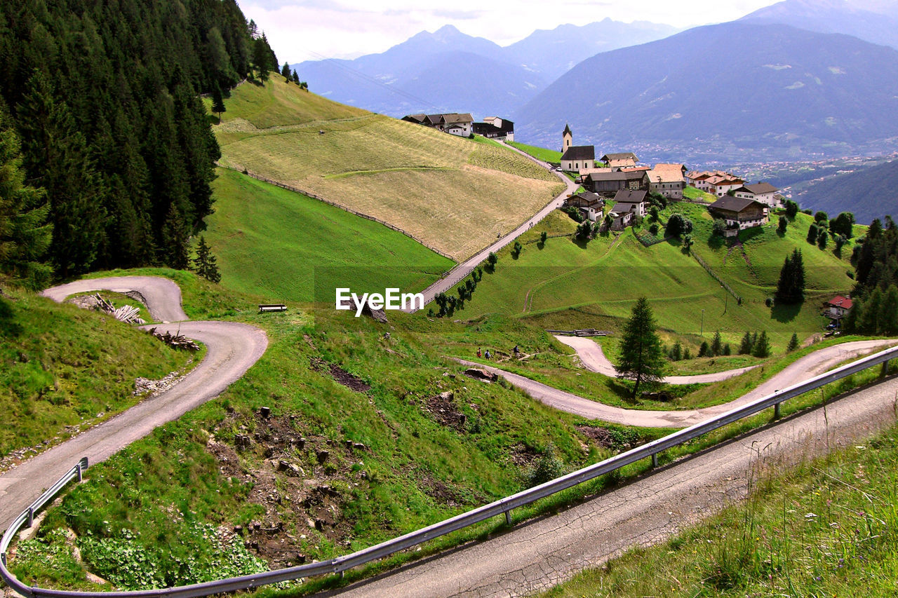 HIGH ANGLE VIEW OF ROAD AMIDST TREES ON MOUNTAINS