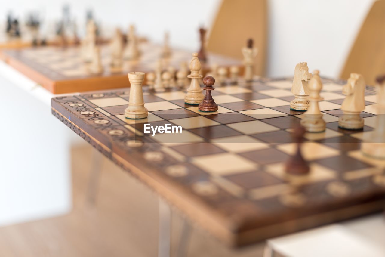 Close-up of chess board with pieces on table