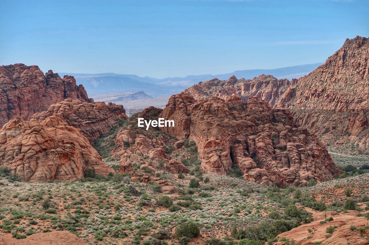 Rock formations on landscape against sky