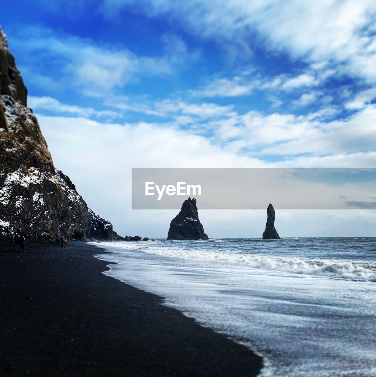 ROCKS ON BEACH AGAINST SKY