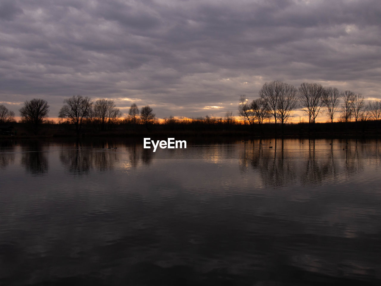 SCENIC VIEW OF LAKE AT SUNSET