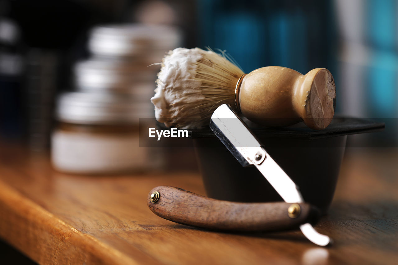 Set of shaving equipment and men's cosmetic products on wooden table, barbershop. shave concept 