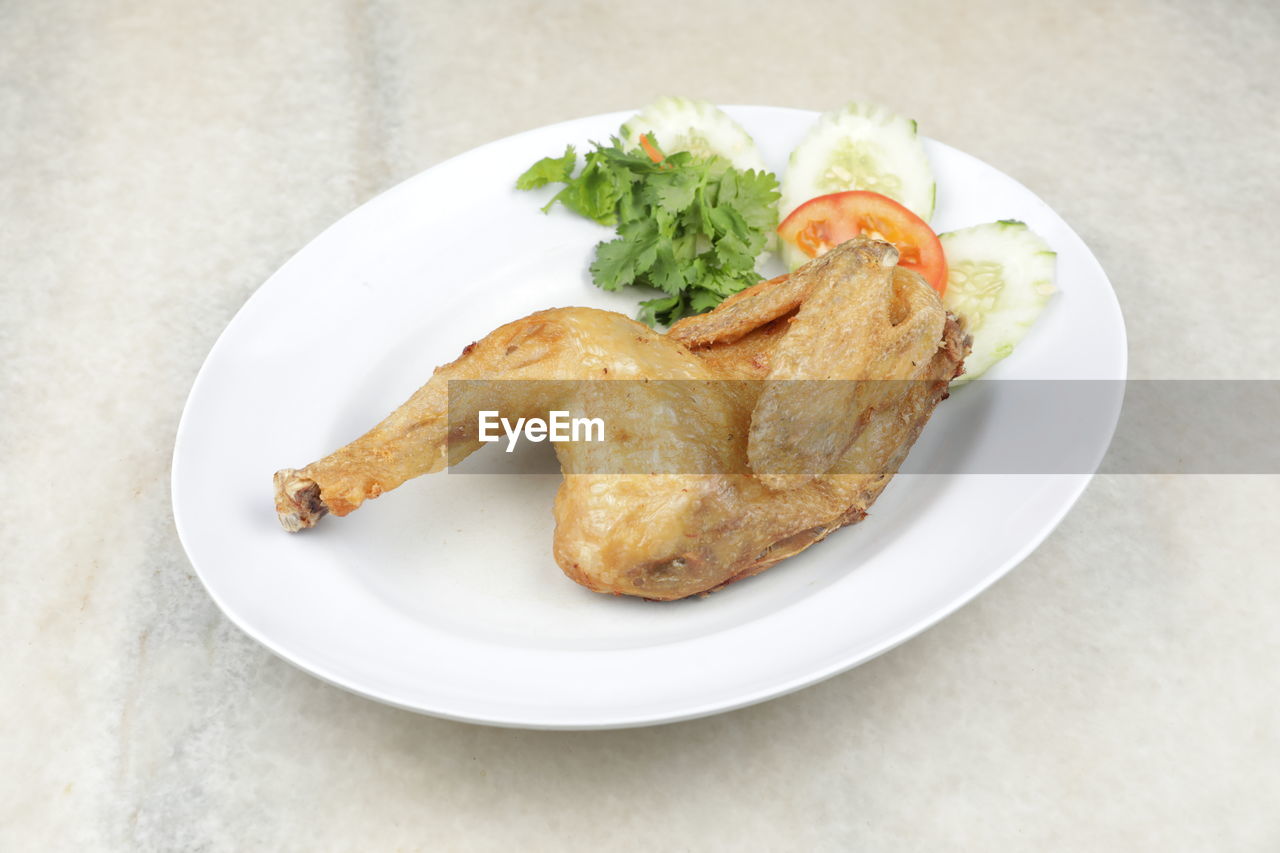 Deep-fried organic chicken serve on white plate