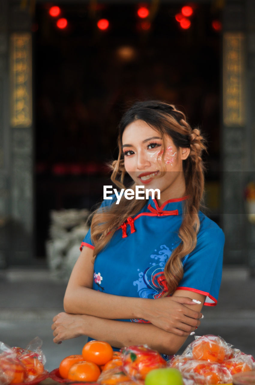 Asian nyonya female portrait in chinese traditional cheongsam, qipao photoshoot chinese new year