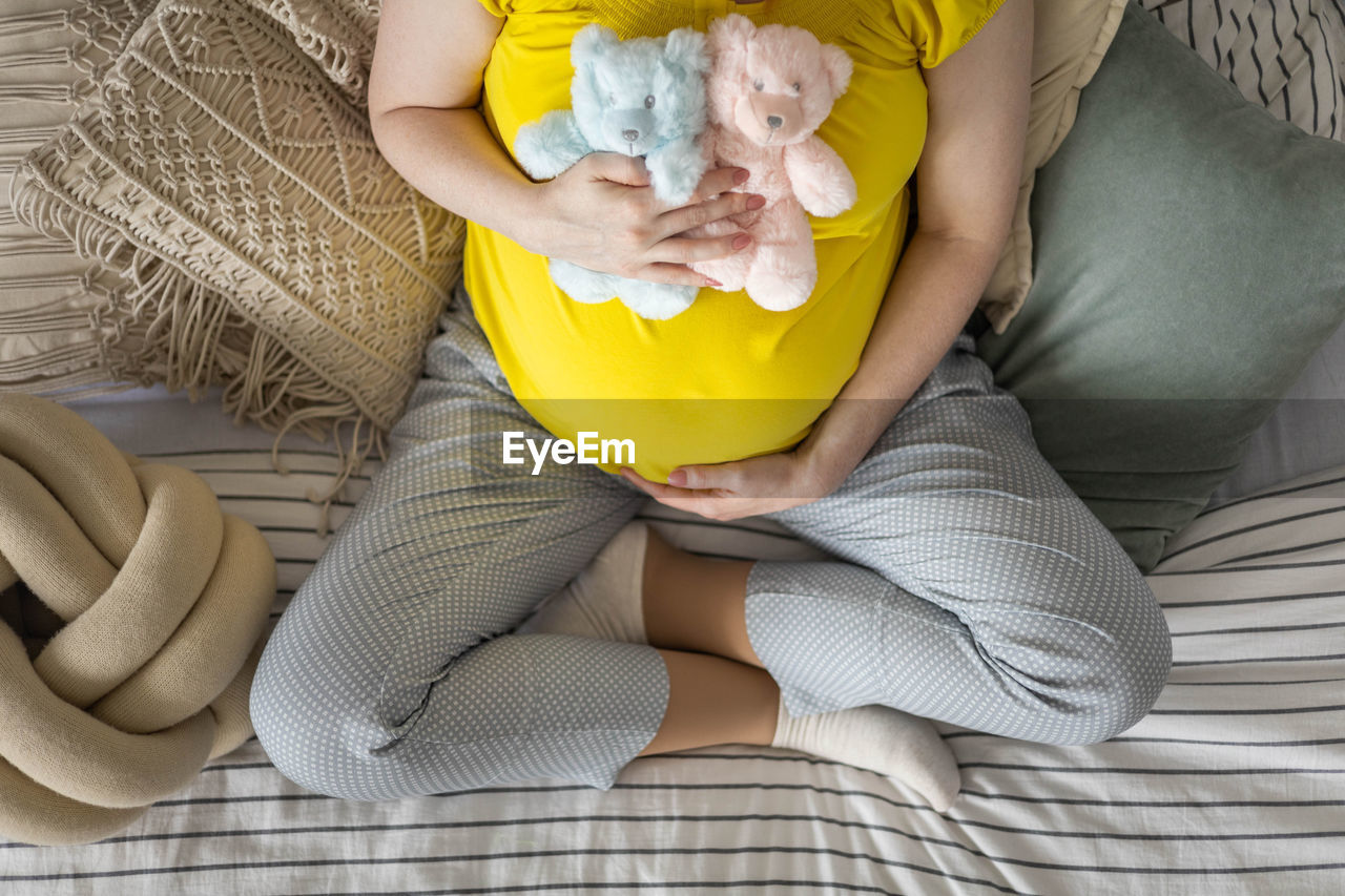 Midsection of woman holding teddy bear