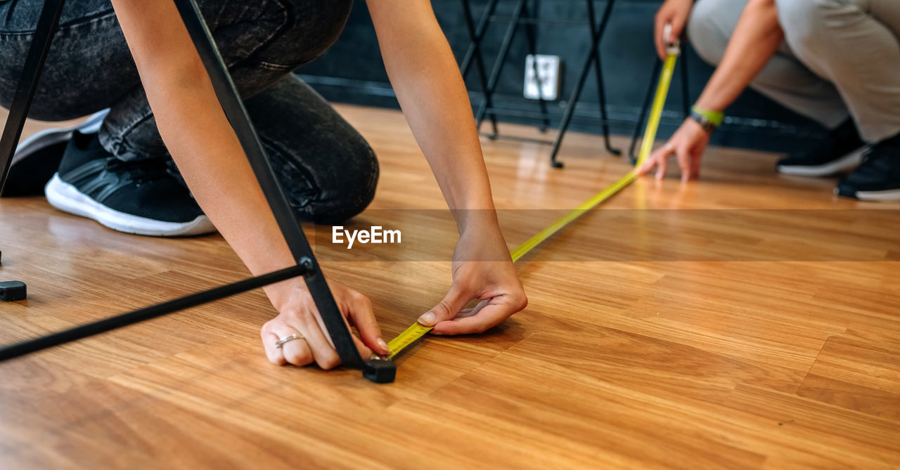 LOW SECTION OF PEOPLE STANDING ON WOOD