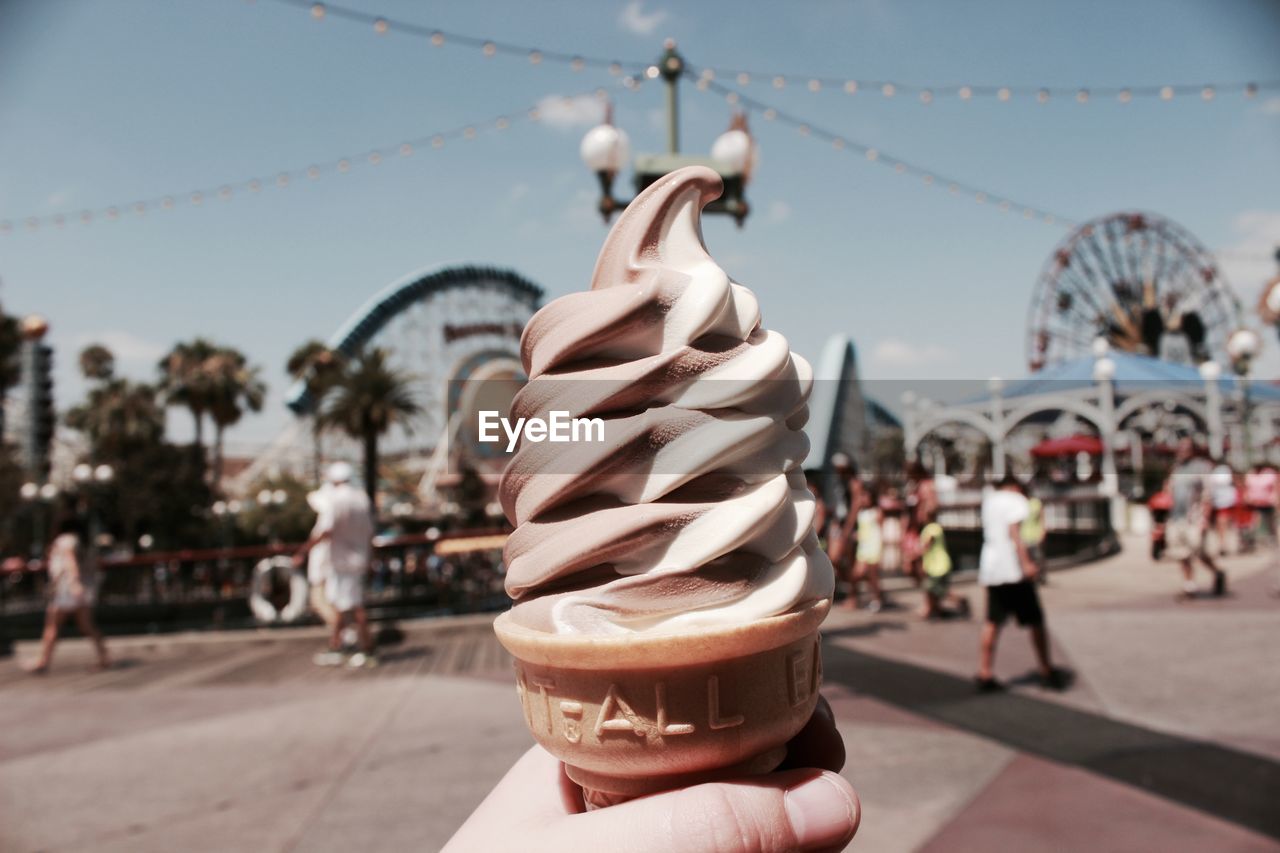 Close-up of ice cream cone against sky