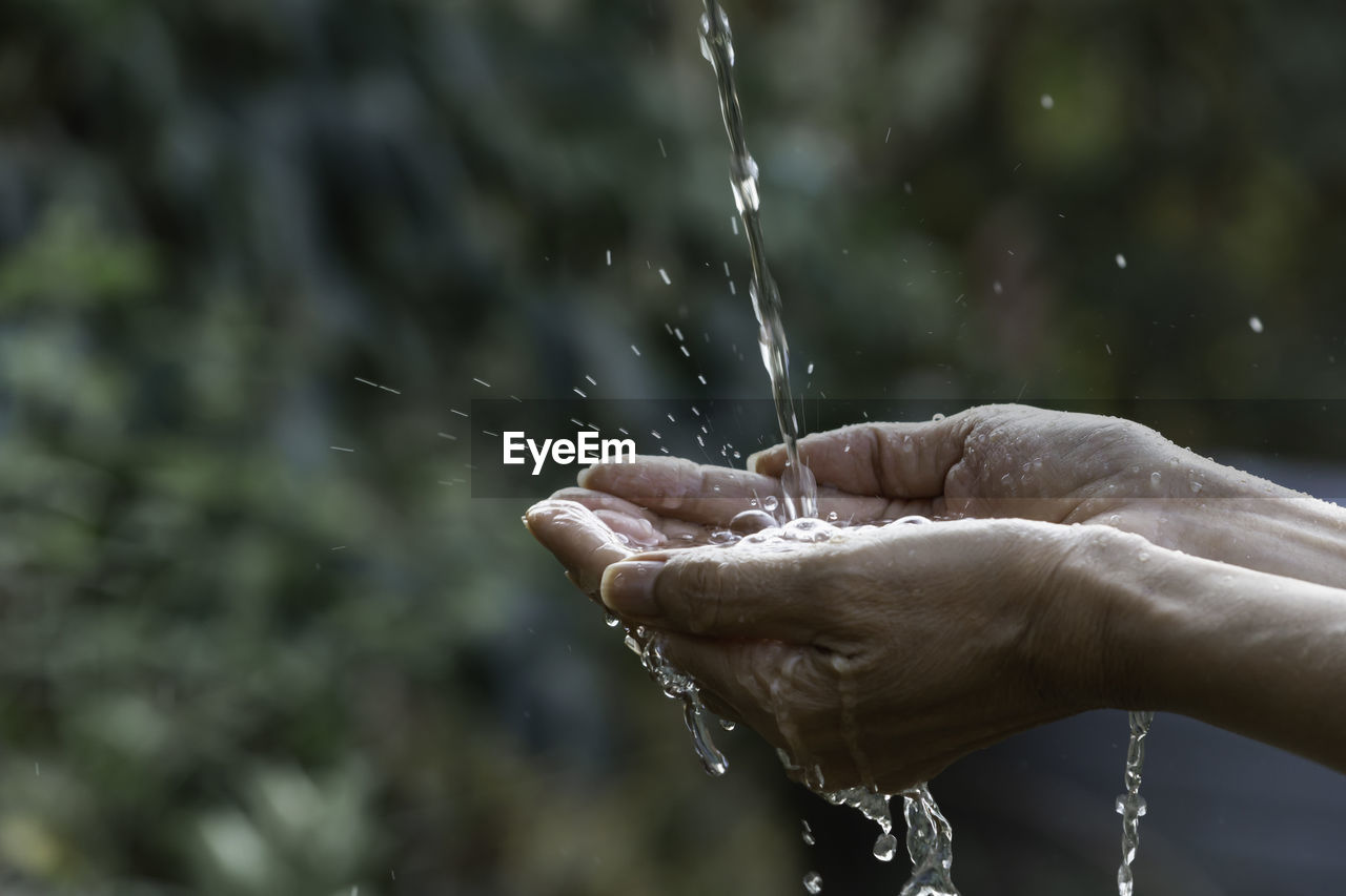 Water falling on hands