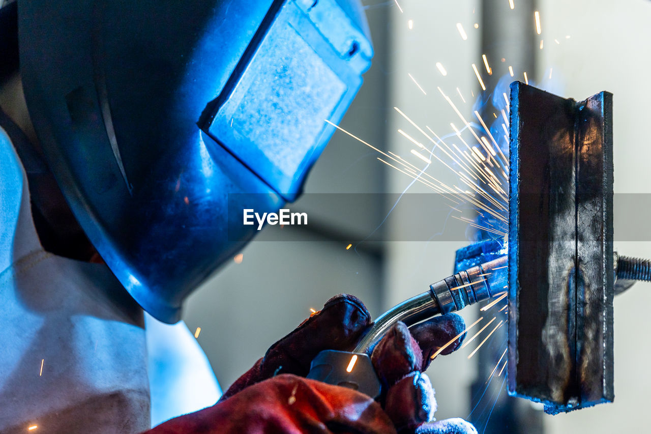 cropped hand of person working on metal