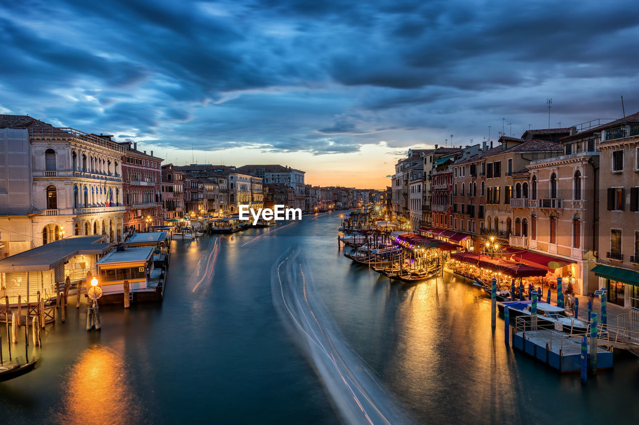 View of boats moored at illuminated city