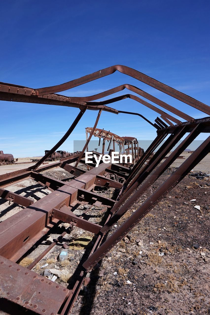 ABANDONED RUSTY AGAINST CLEAR SKY