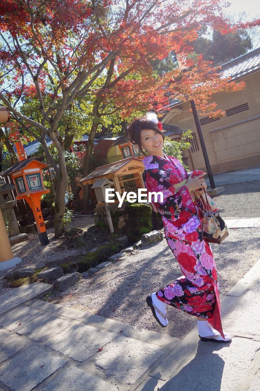 LOW ANGLE VIEW OF GIRL ON TREE