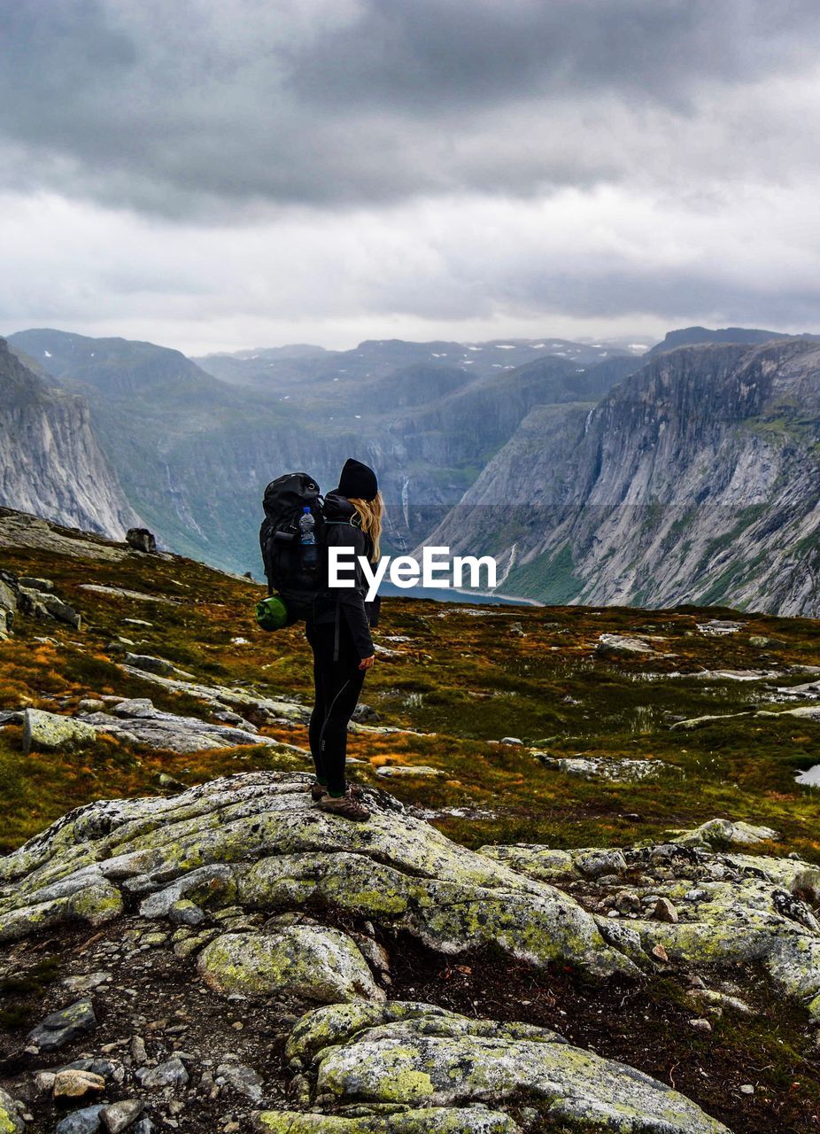 Full length of hiker standing on mountain