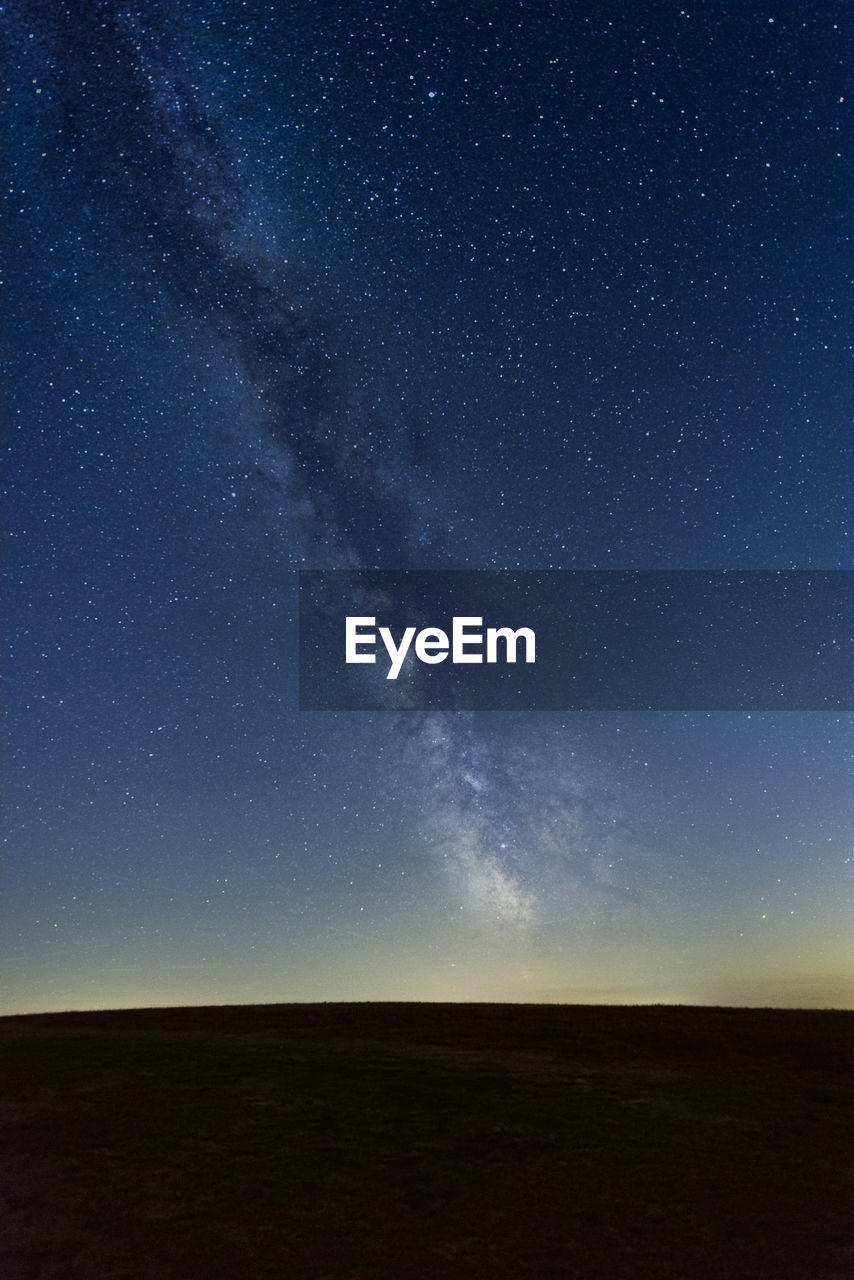 low angle view of silhouette mountain against sky at night