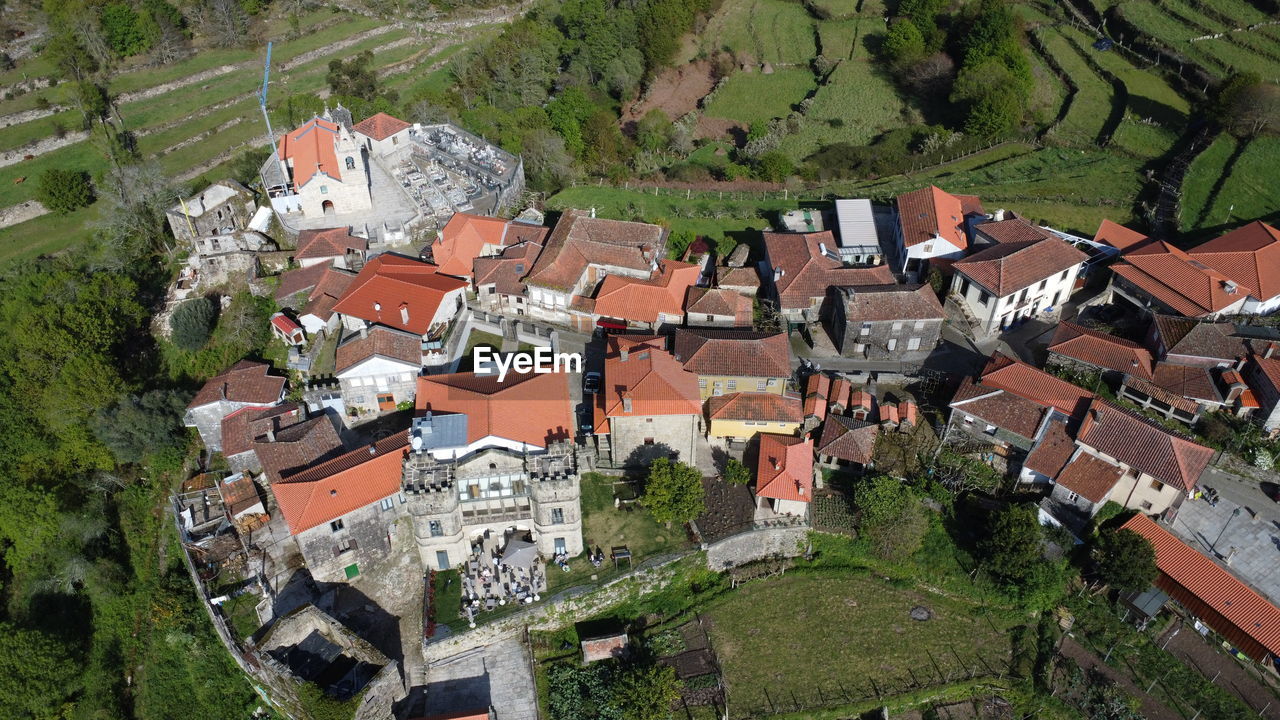 architecture, aerial photography, town, high angle view, built structure, building exterior, building, bird's-eye view, residential area, roof, residential district, house, village, city, neighbourhood, no people, nature, suburb, aerial view, plant, landscape, day, estate, environment, outdoors, land, tree, green, travel destinations, field, community, scenics - nature, rural scene