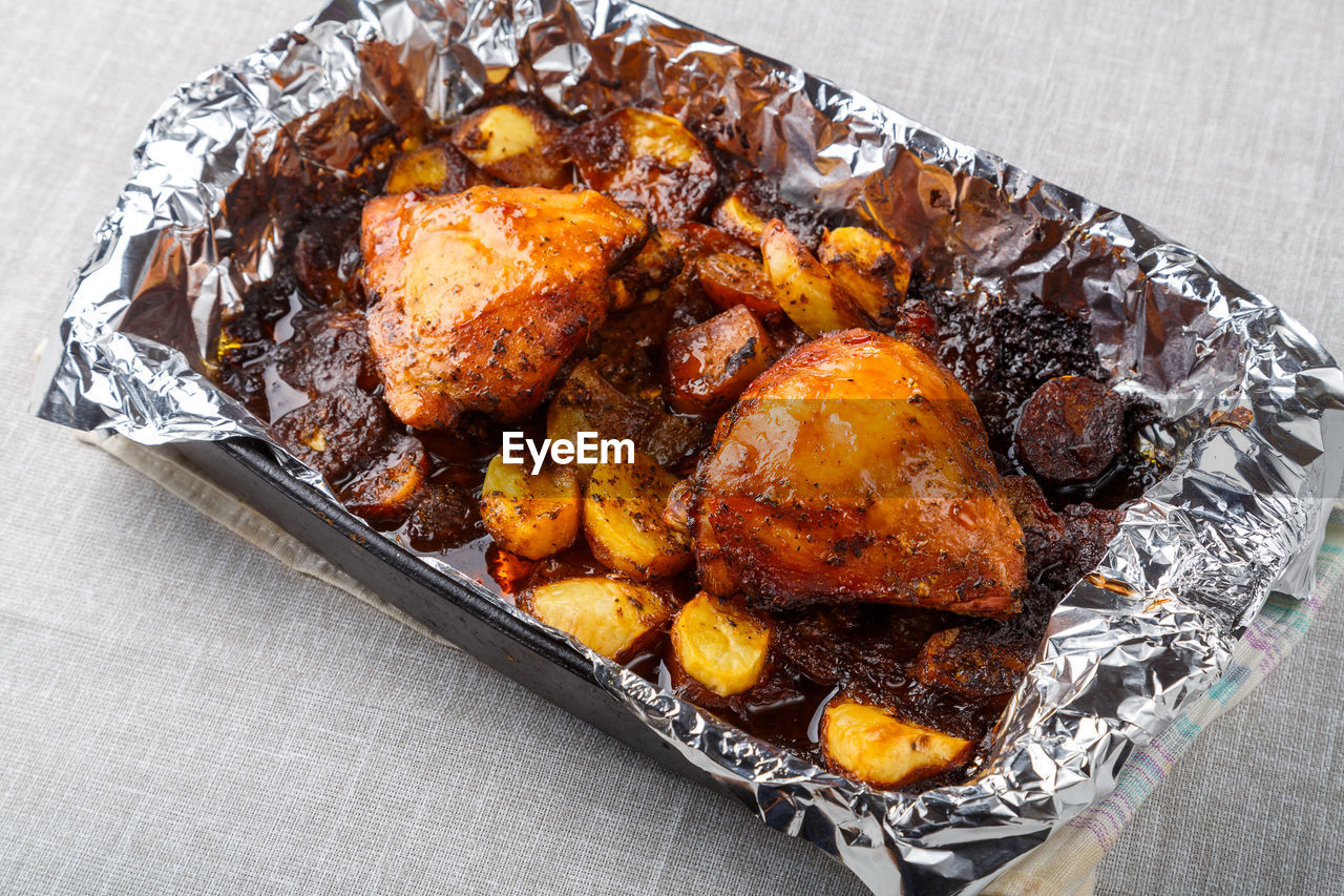 food, food and drink, fried food, meat, dish, freshness, no people, high angle view, produce, fast food, chicken meat, indoors, chicken, still life, cuisine, roasted, fried, close-up, meal, table, healthy eating, studio shot, wellbeing, foil