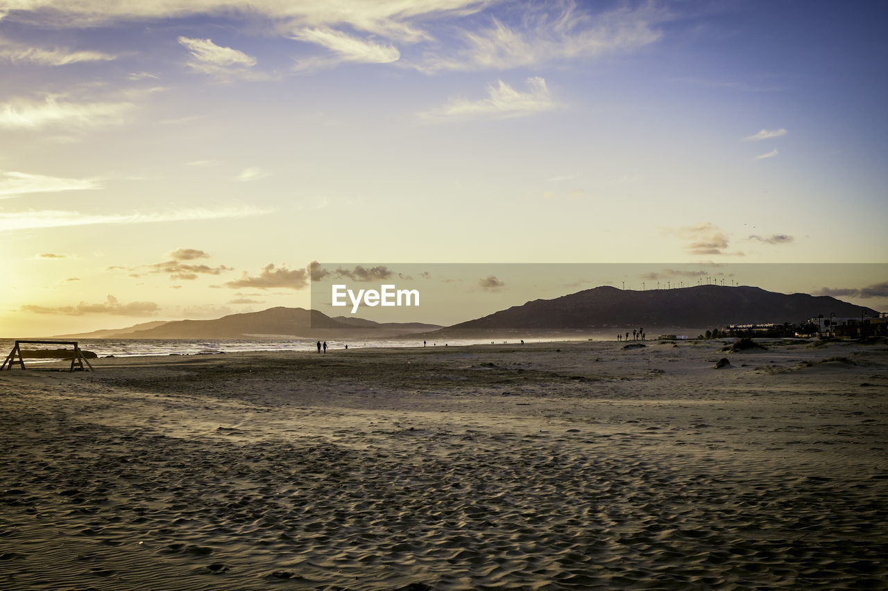 Scenic view of beach against sky during sunset